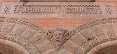 archway of courthouse building with the words &quot;Faribault County&quot; at the top