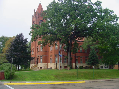 large brick building partially obscured by trees