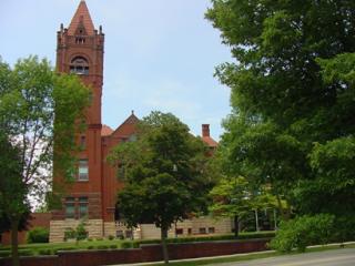 large building partially obscured by trees