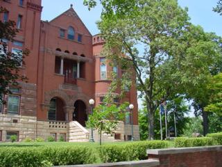 large building partially obscured by trees