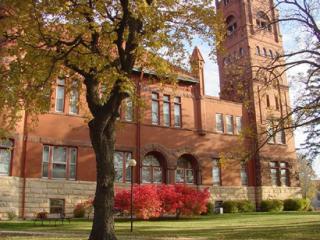 large building partially obscured by trees