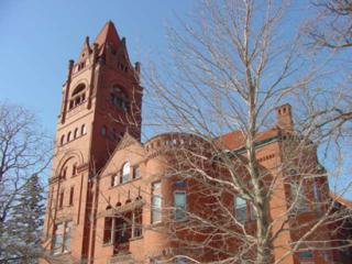 large building with a leafless tree in front